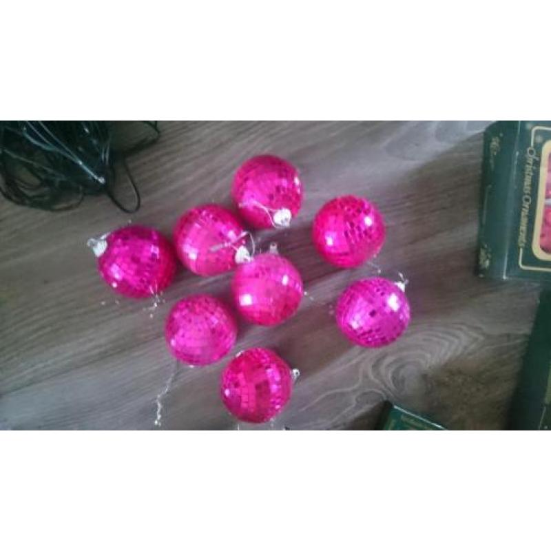Zilver en roze kerstballen, piek, slingers, lampjes en meer.
